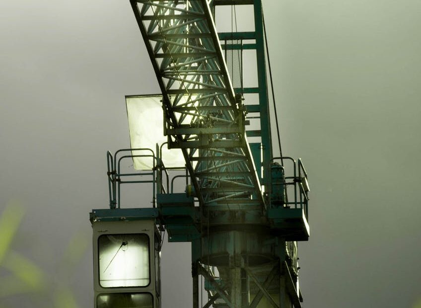 tilt lens photography of black steel crane